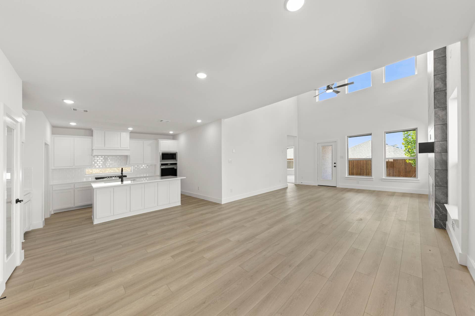 Spacious open-concept kitchen and living area with high ceilings and modern finishes.