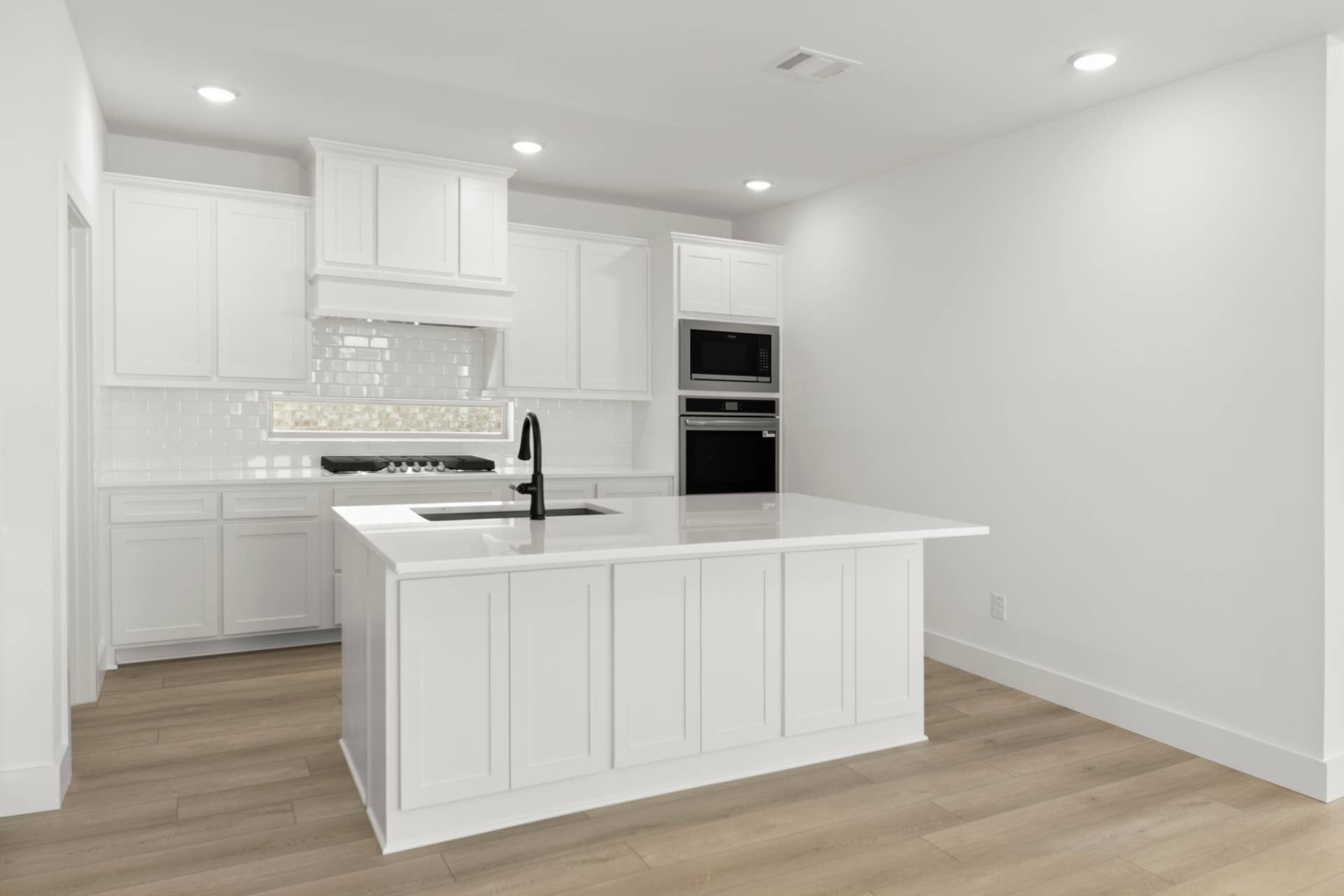 Modern kitchen with white cabinetry, island, and stainless steel appliances.