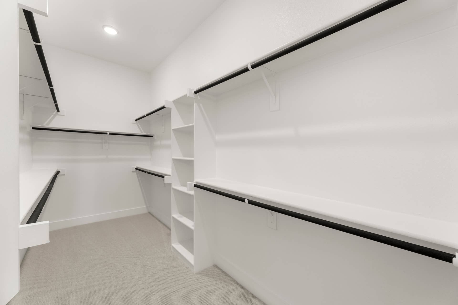 Spacious walk-in closet with ample shelving and hanging space.