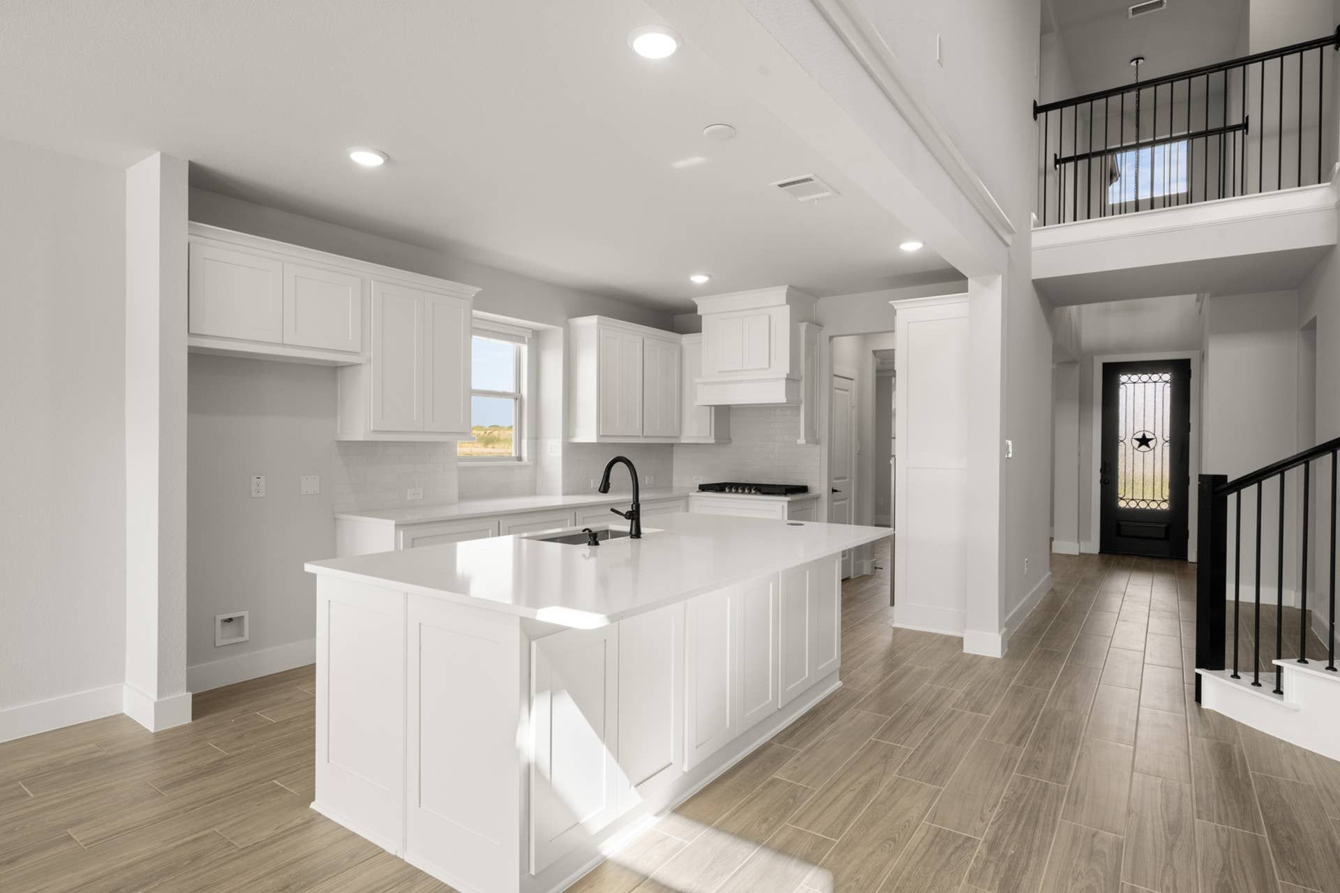Modern kitchen interior with white cabinetry and central island.