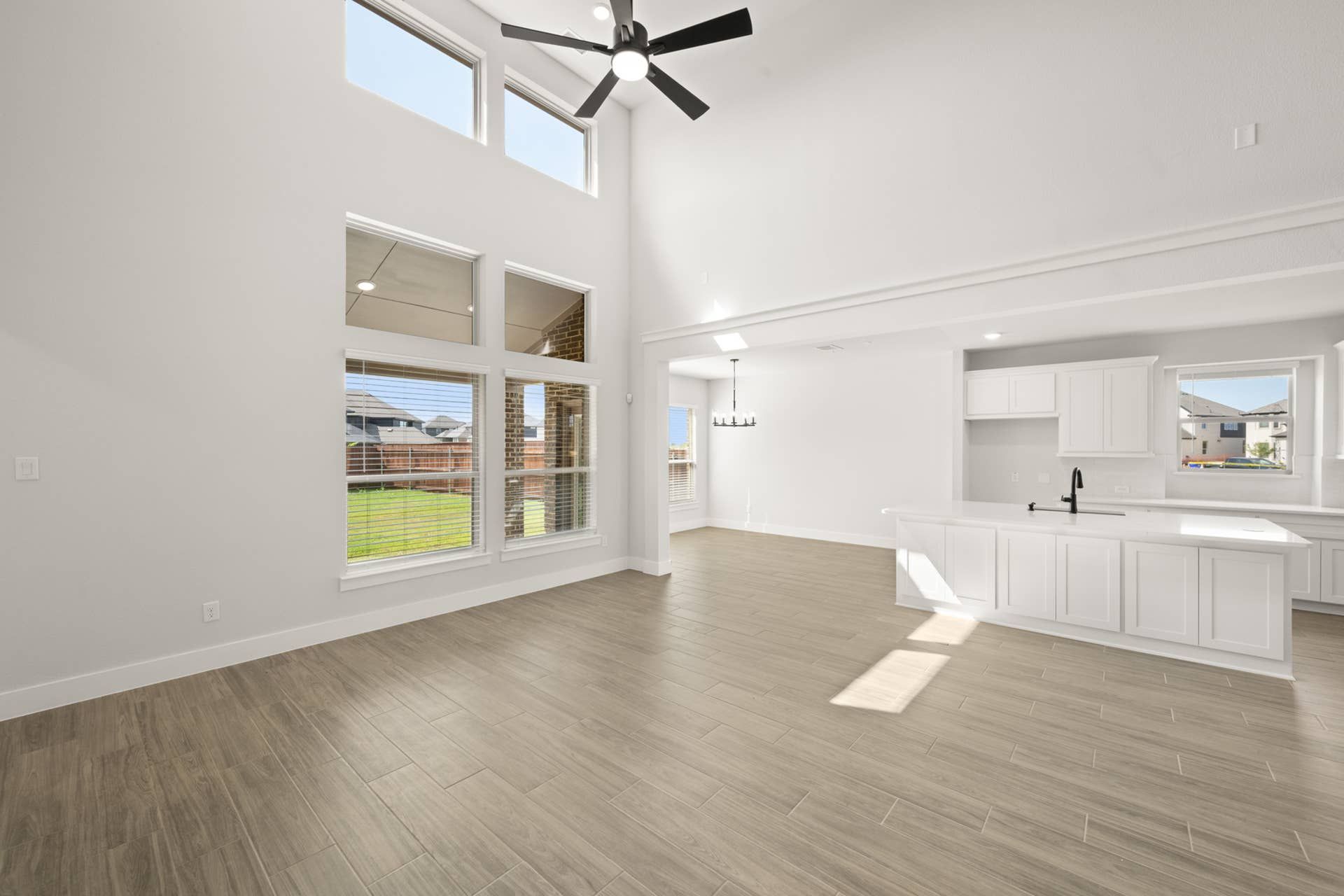 Spacious living room with high ceilings and large windows for natural light.