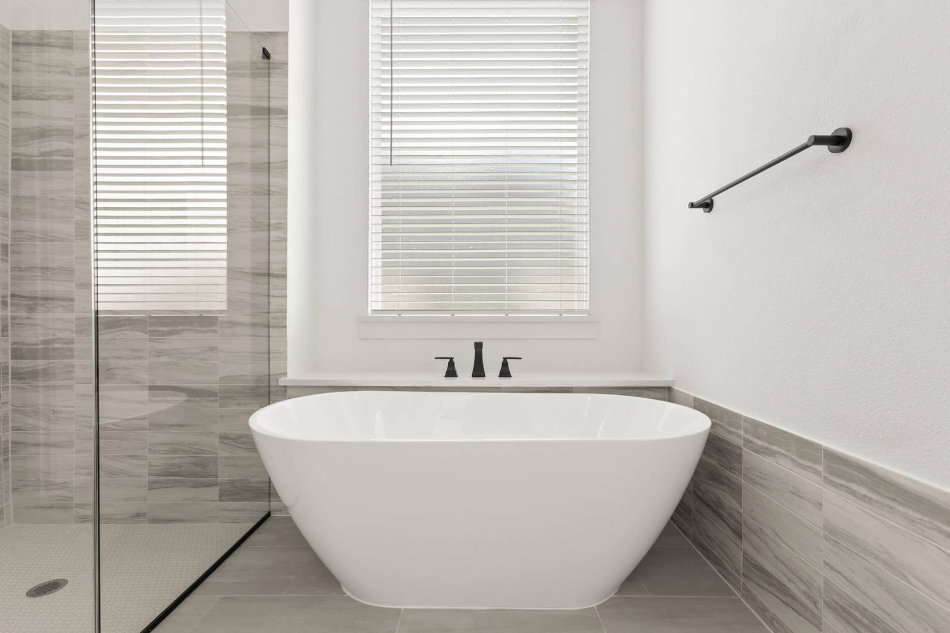 Modern bathroom with freestanding tub and glass-enclosed shower.