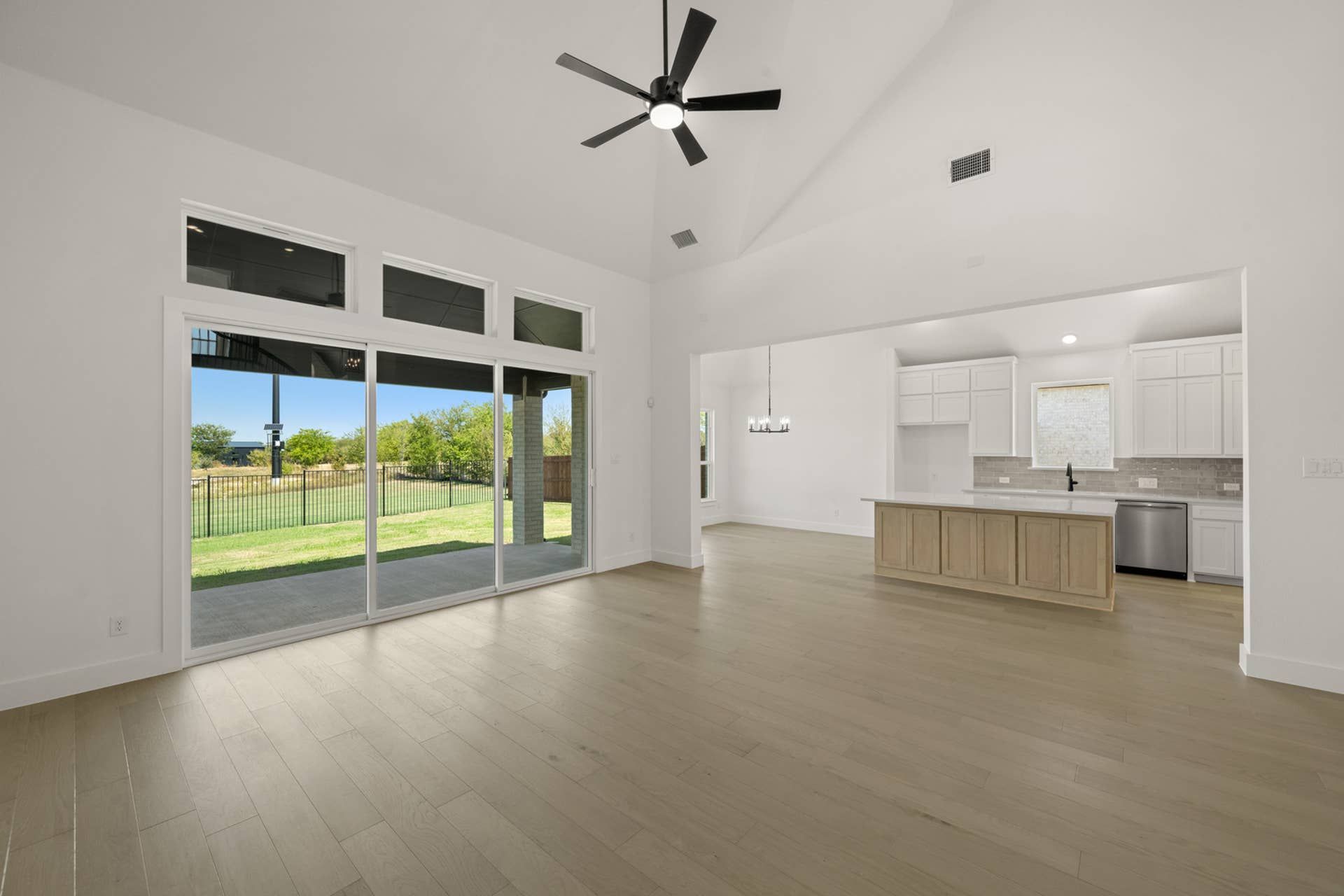 Spacious living room with open floor plan and large sliding glass doors.