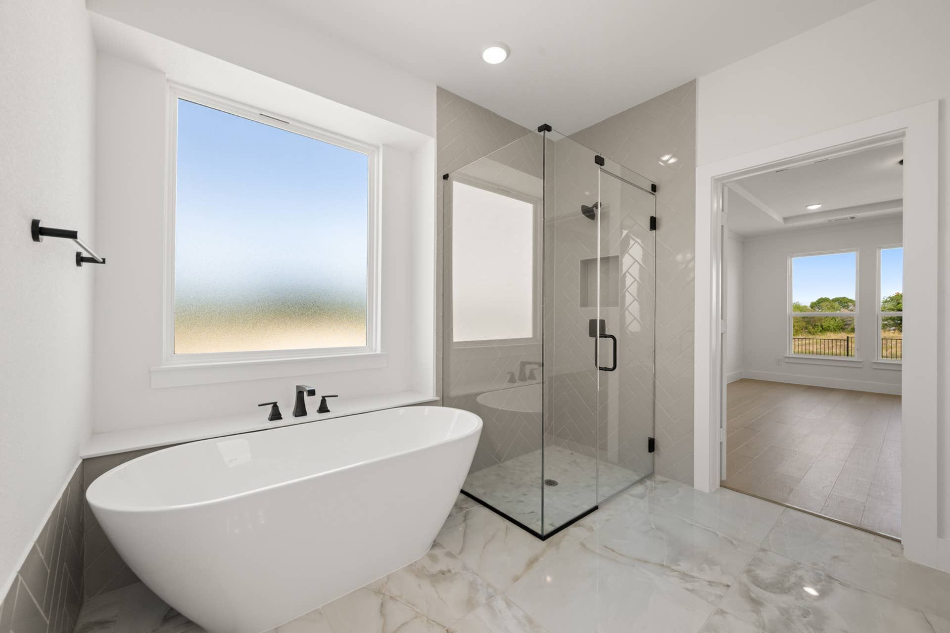 Elegant bathroom with freestanding tub and glass-enclosed shower.