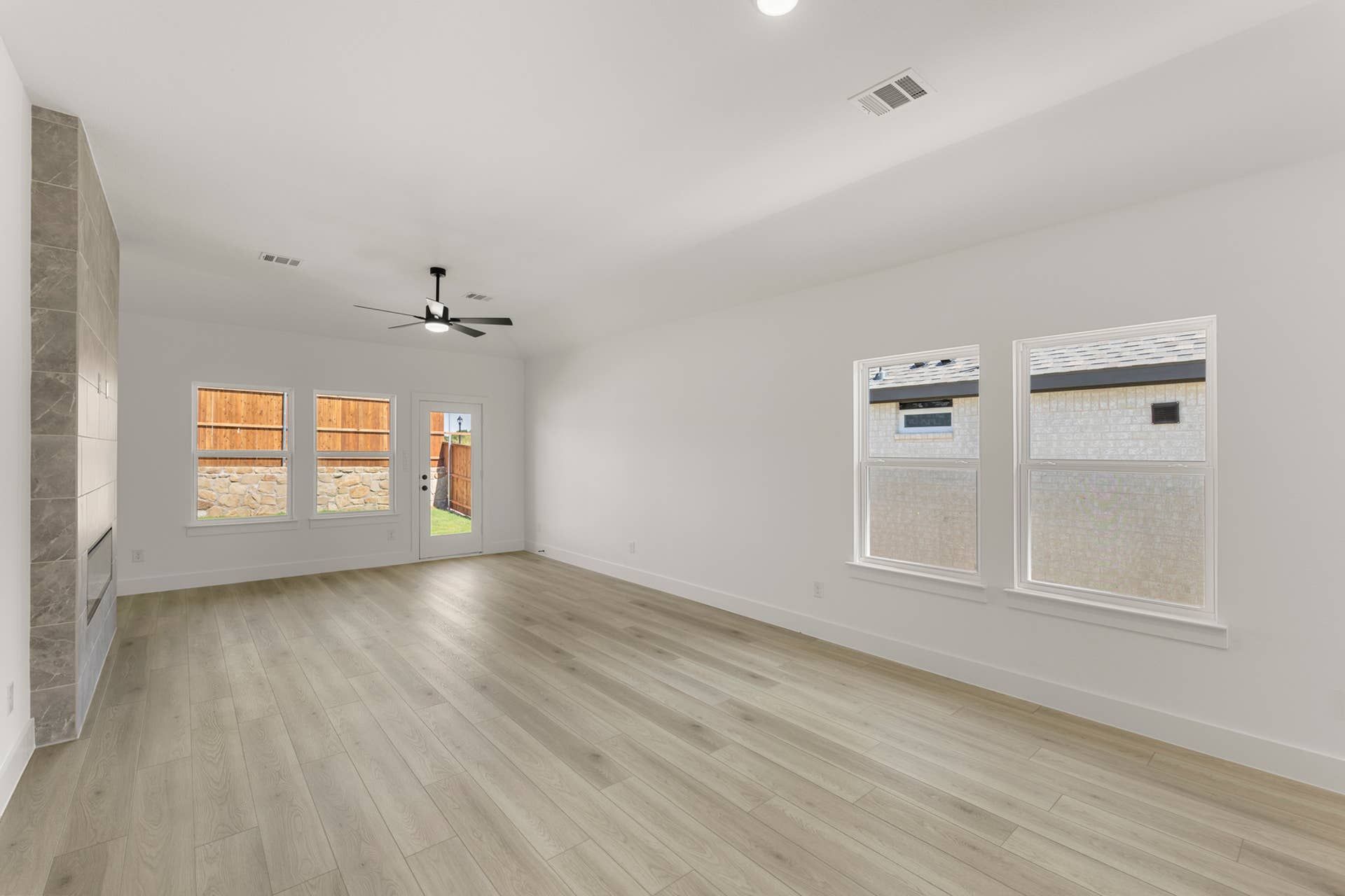 Spacious dining room with hardwood floors and large windows.
