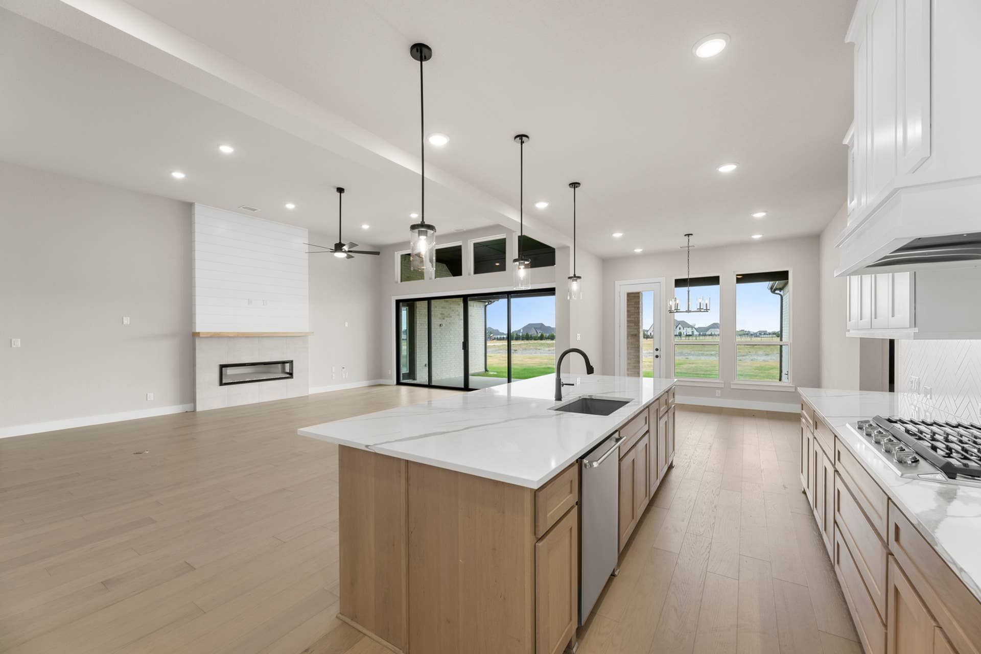 Spacious open-concept kitchen and living area with modern finishes and large windows.