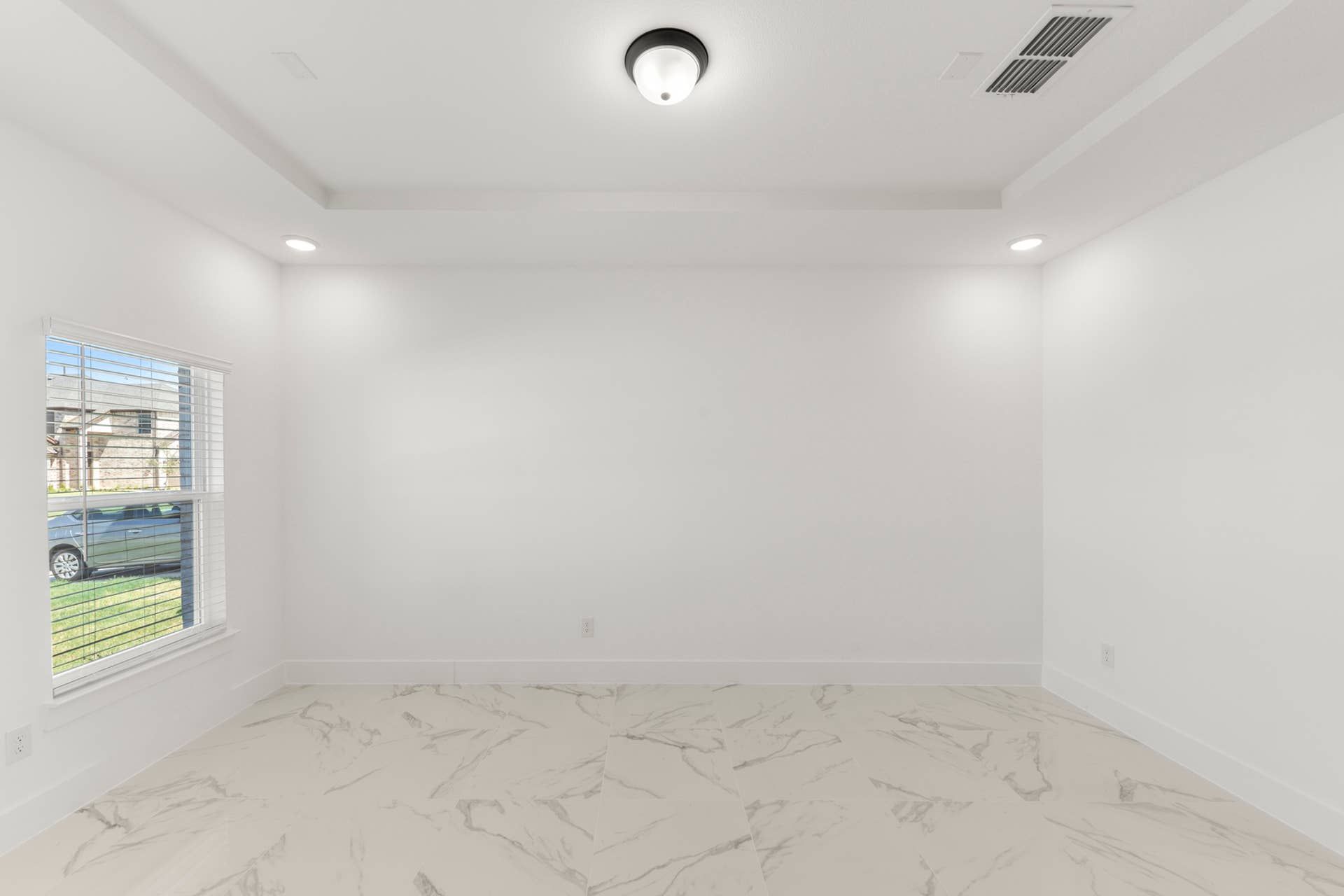 Bright dining area with marble flooring and recessed lighting.