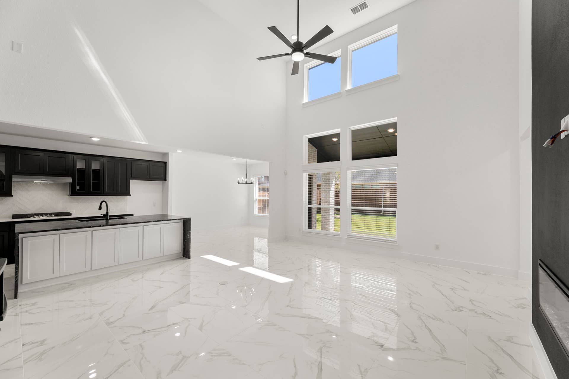 Spacious modern kitchen with high ceilings and large windows.