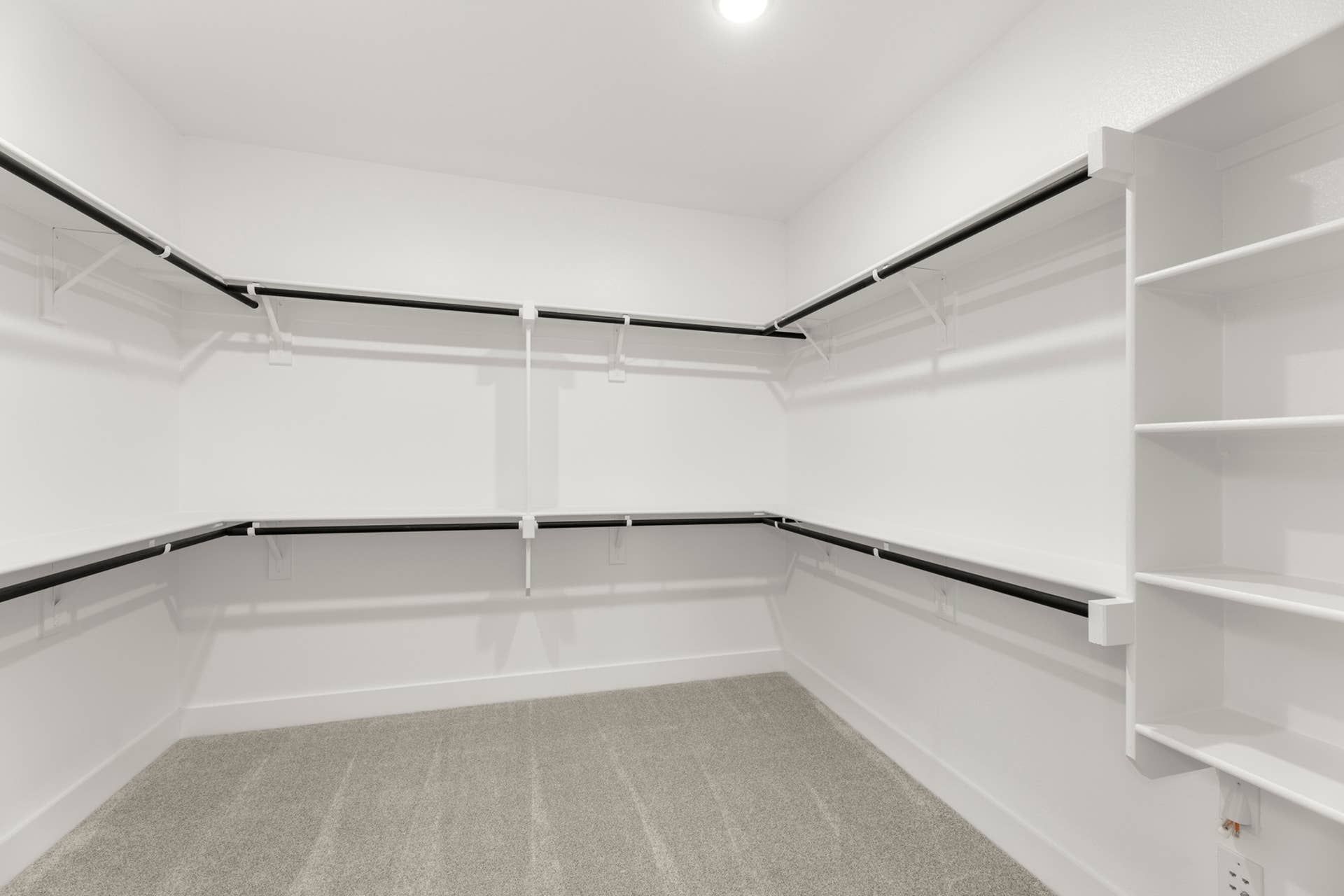 Spacious walk-in closet with shelving and hanging rods.