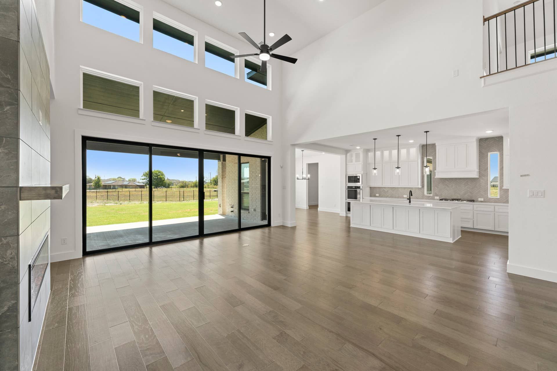 Expansive open-concept living area with high ceilings and modern kitchen.