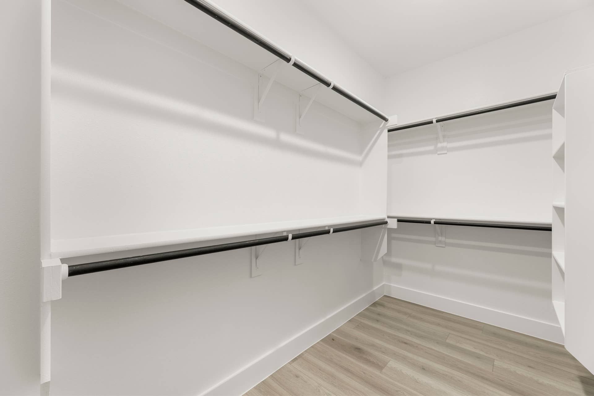 Spacious walk-in closet with shelving and hanging rods.