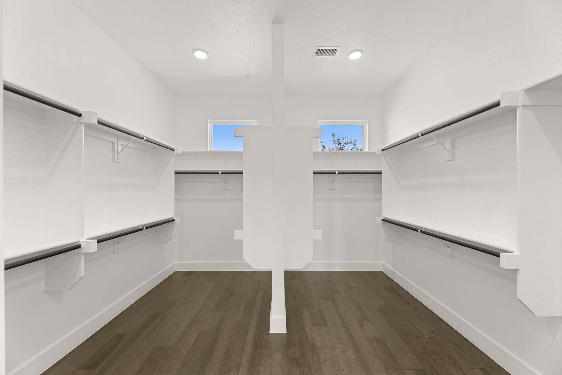 Spacious walk-in closet with built-in shelving and natural light.