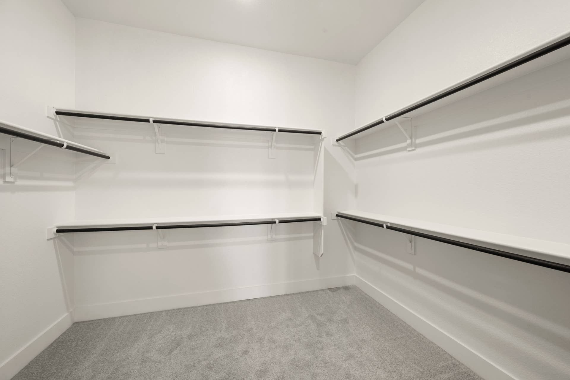Spacious walk-in closet with ample shelving and hanging space.