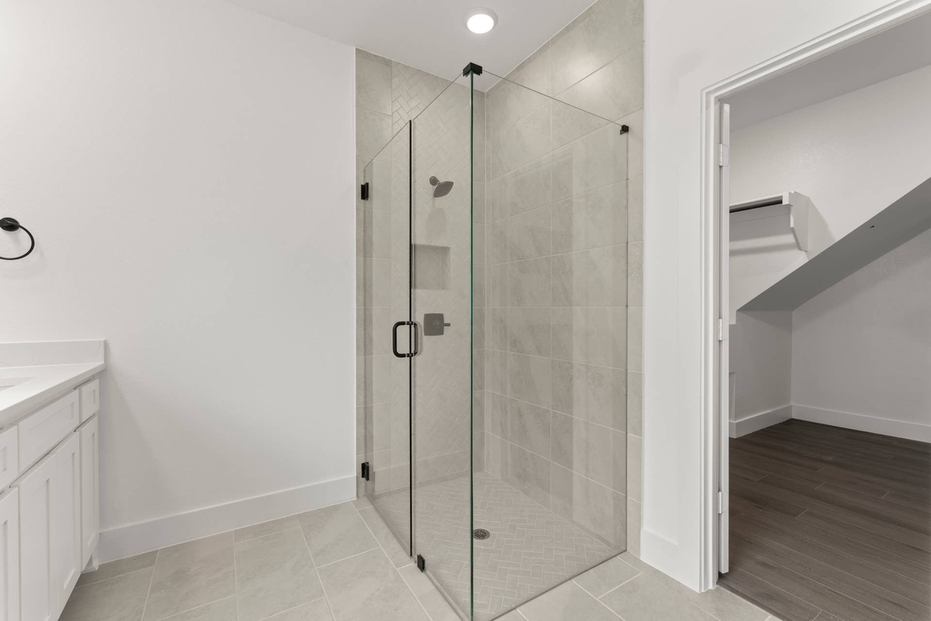 Modern bathroom with glass-enclosed shower and sleek tile design.