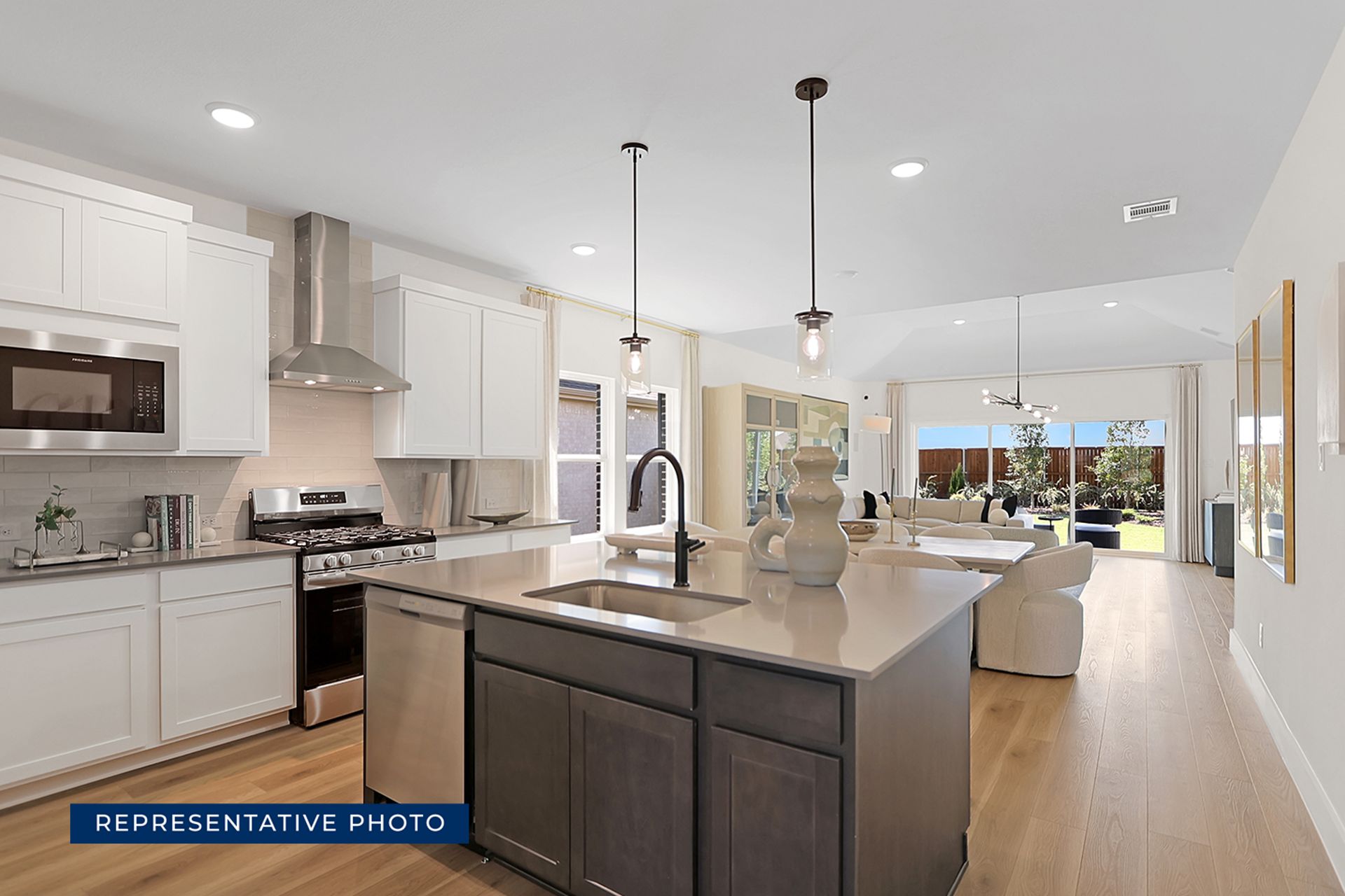 Modern open-plan kitchen and living area with large windows and stylish decor.