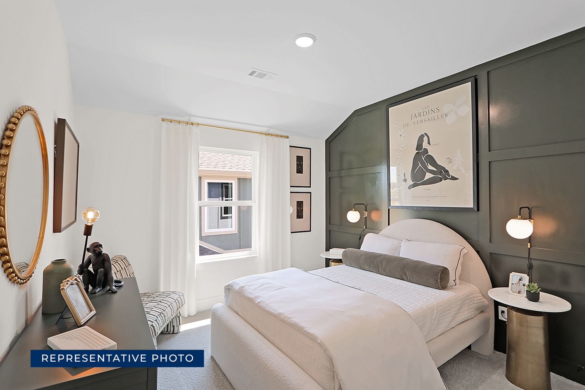 Modern bedroom with elegant decor and large window with ample natural light.
