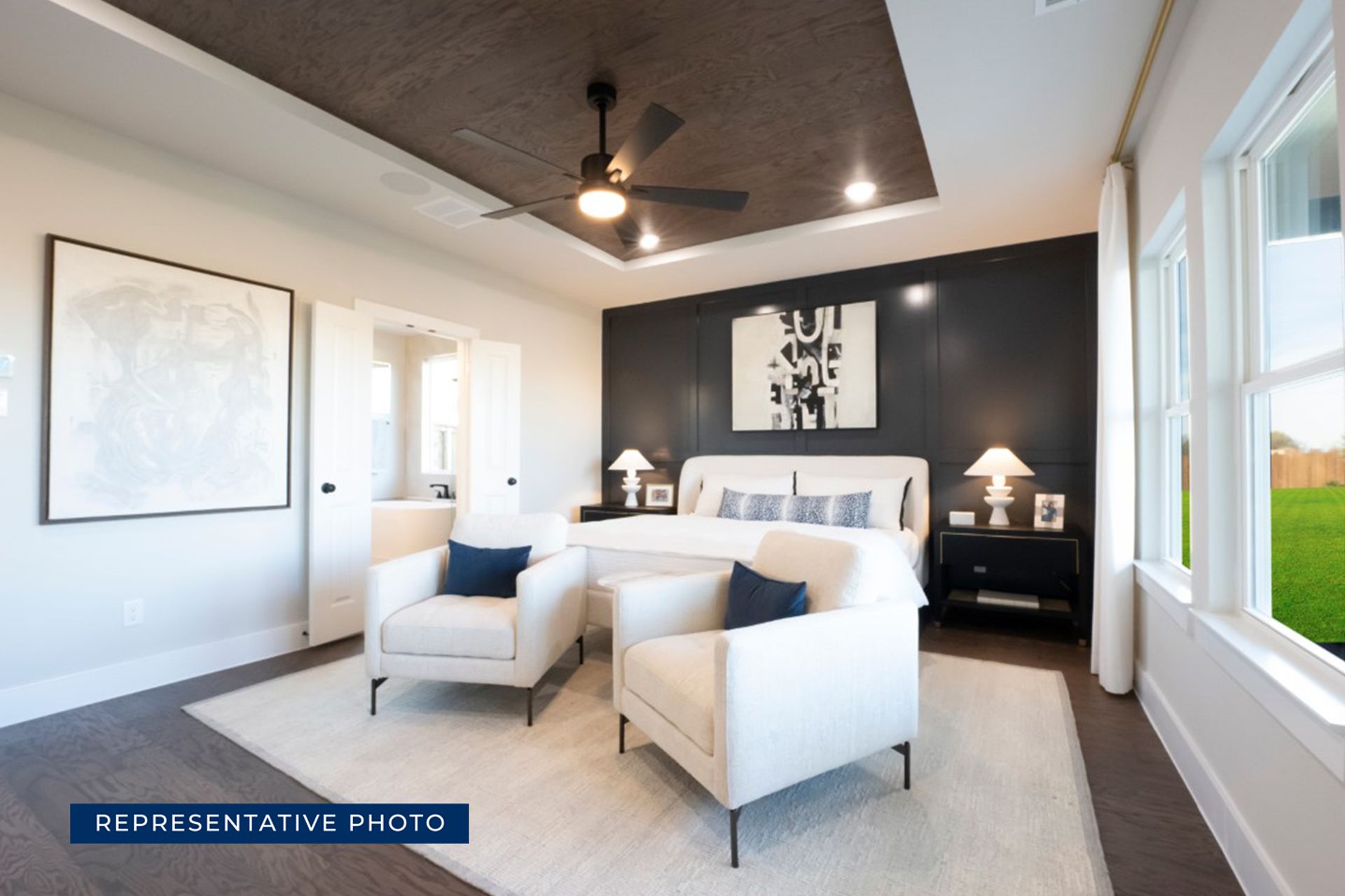 Modern bedroom with ceiling fan, large windows, and stylish decor.