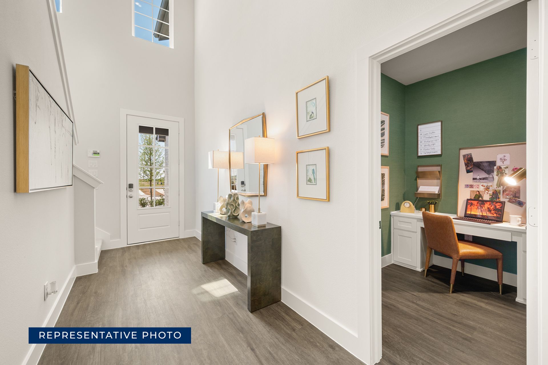 Modern home entryway with decor and adjacent office space.