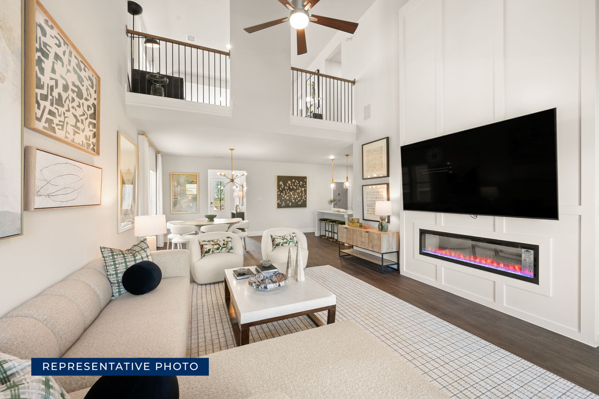 Modern living room with high ceiling, fireplace, and stylish decor.