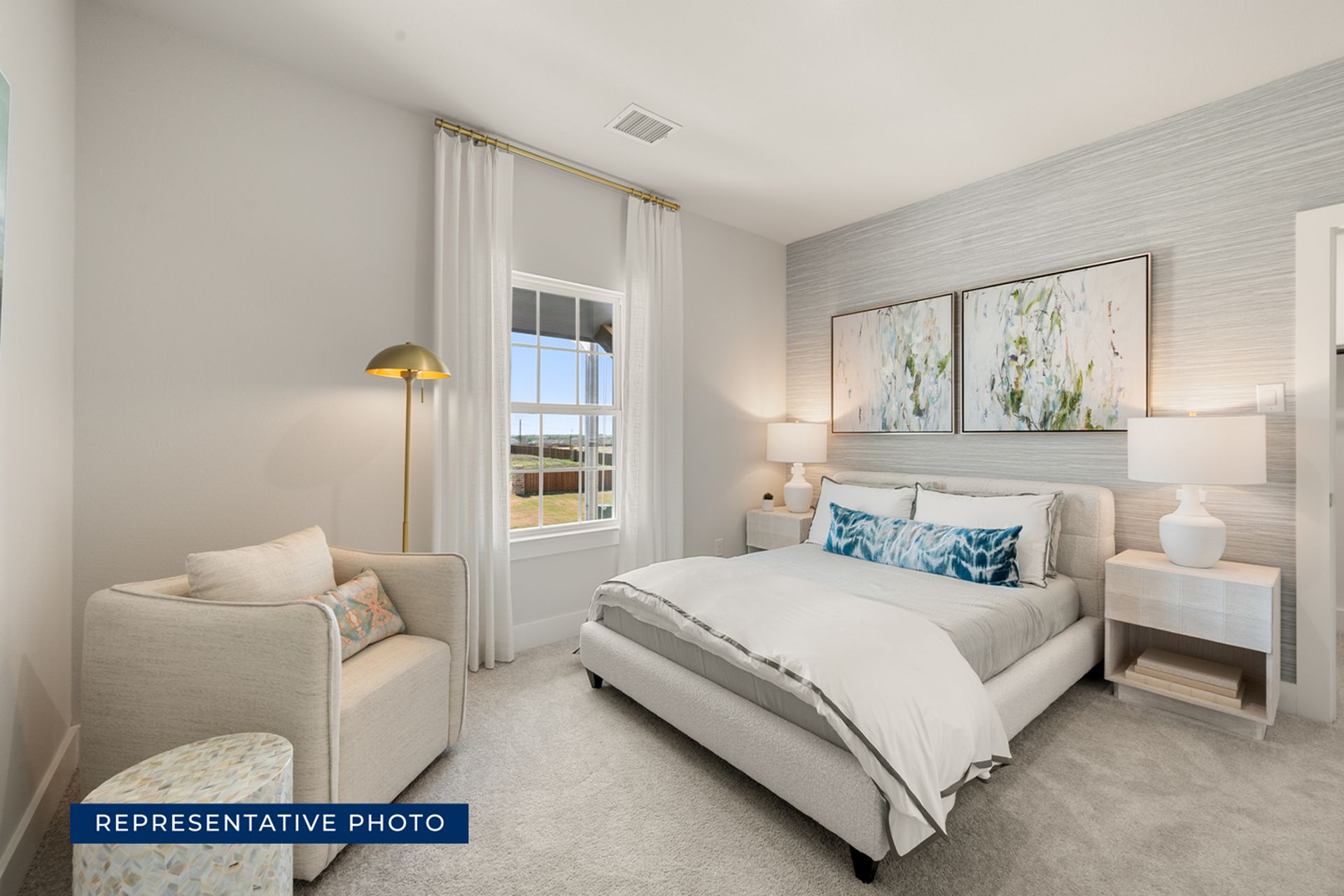 Cozy bedroom with modern decor, large window, and elegant artwork.