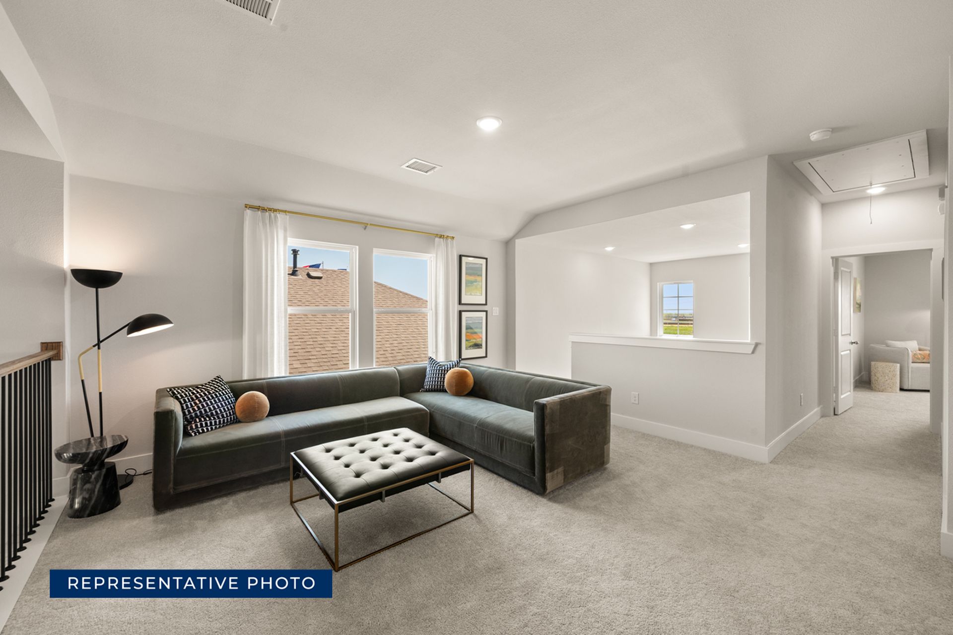 Modern living room with sectional sofa and natural light.