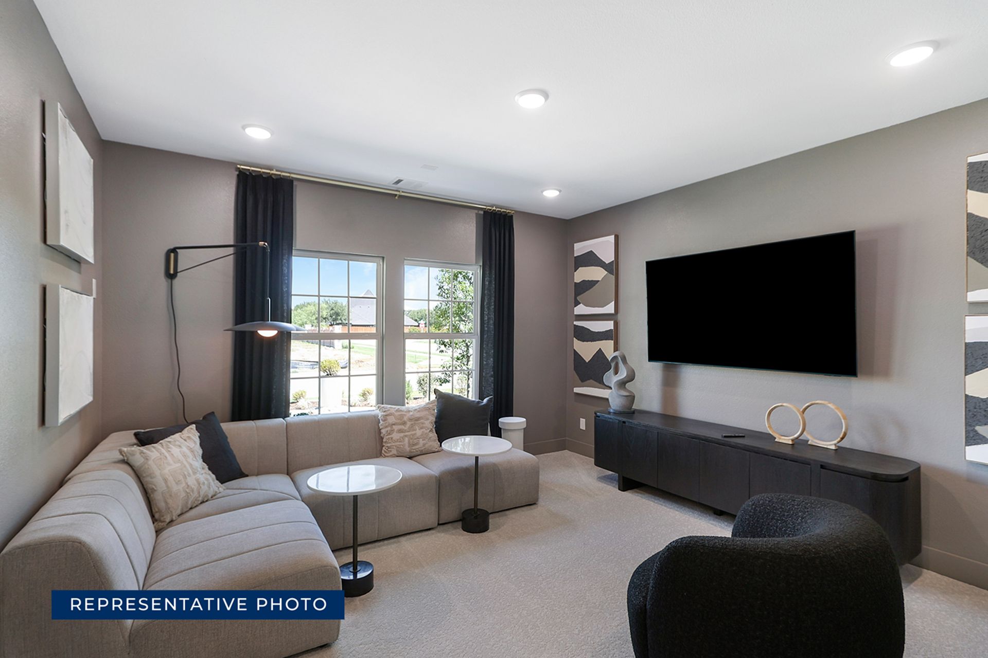 Representative photo of modern living room with sectional sofa and large TV.
