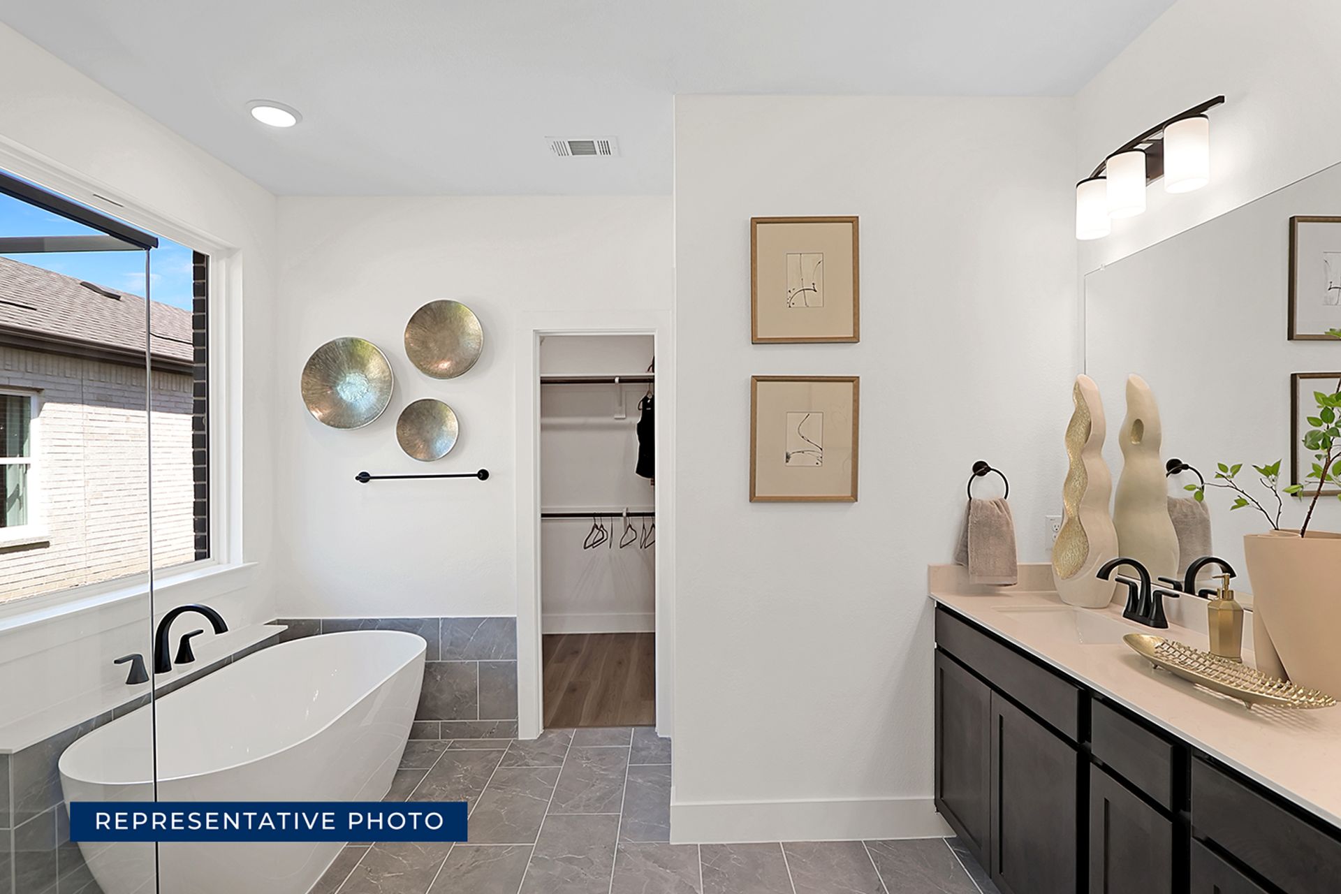 Representative photo of modern bathroom with freestanding tub and double vanity.