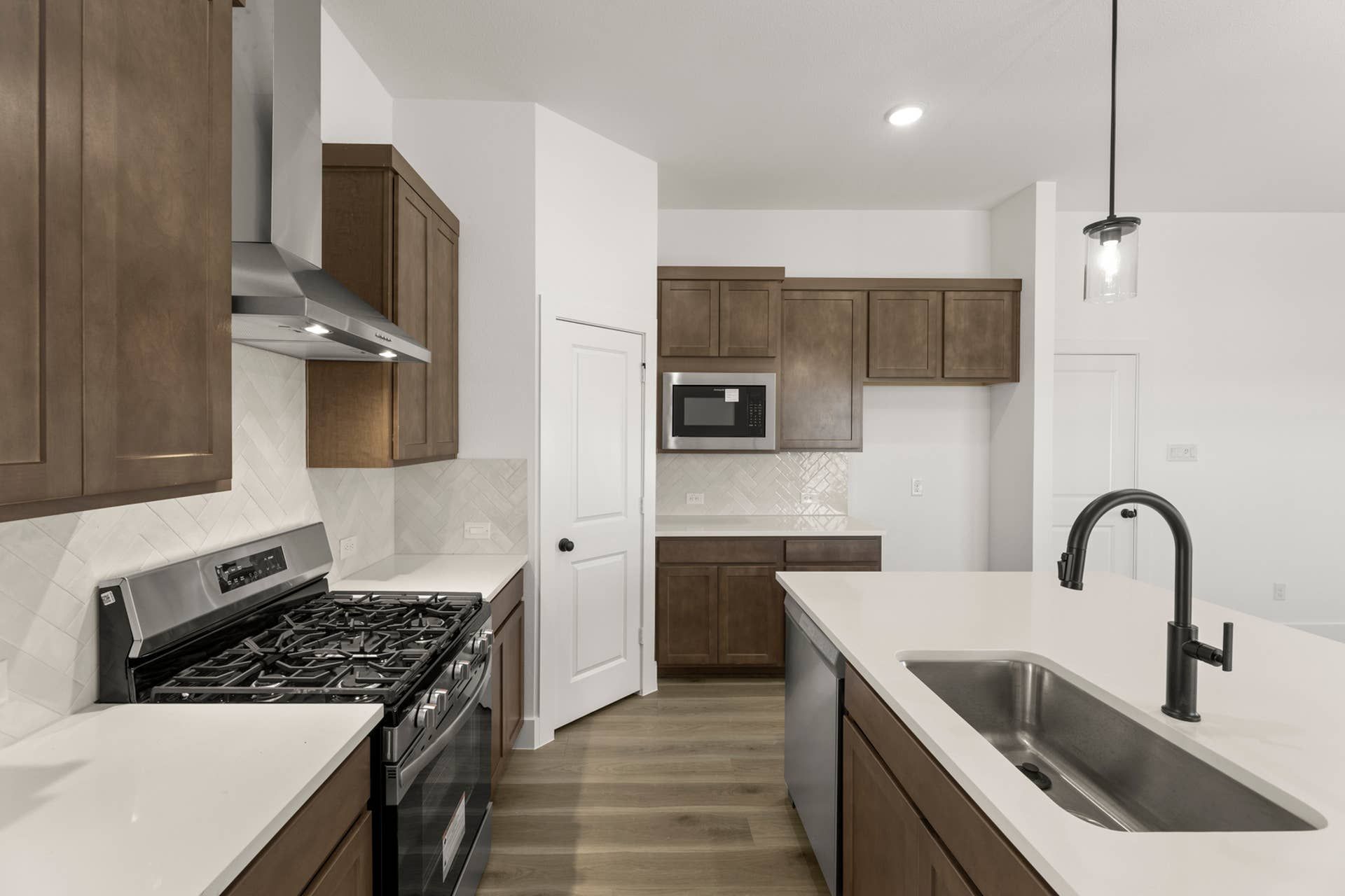 Modern kitchen with stainless steel appliances and sleek wood cabinetry.
