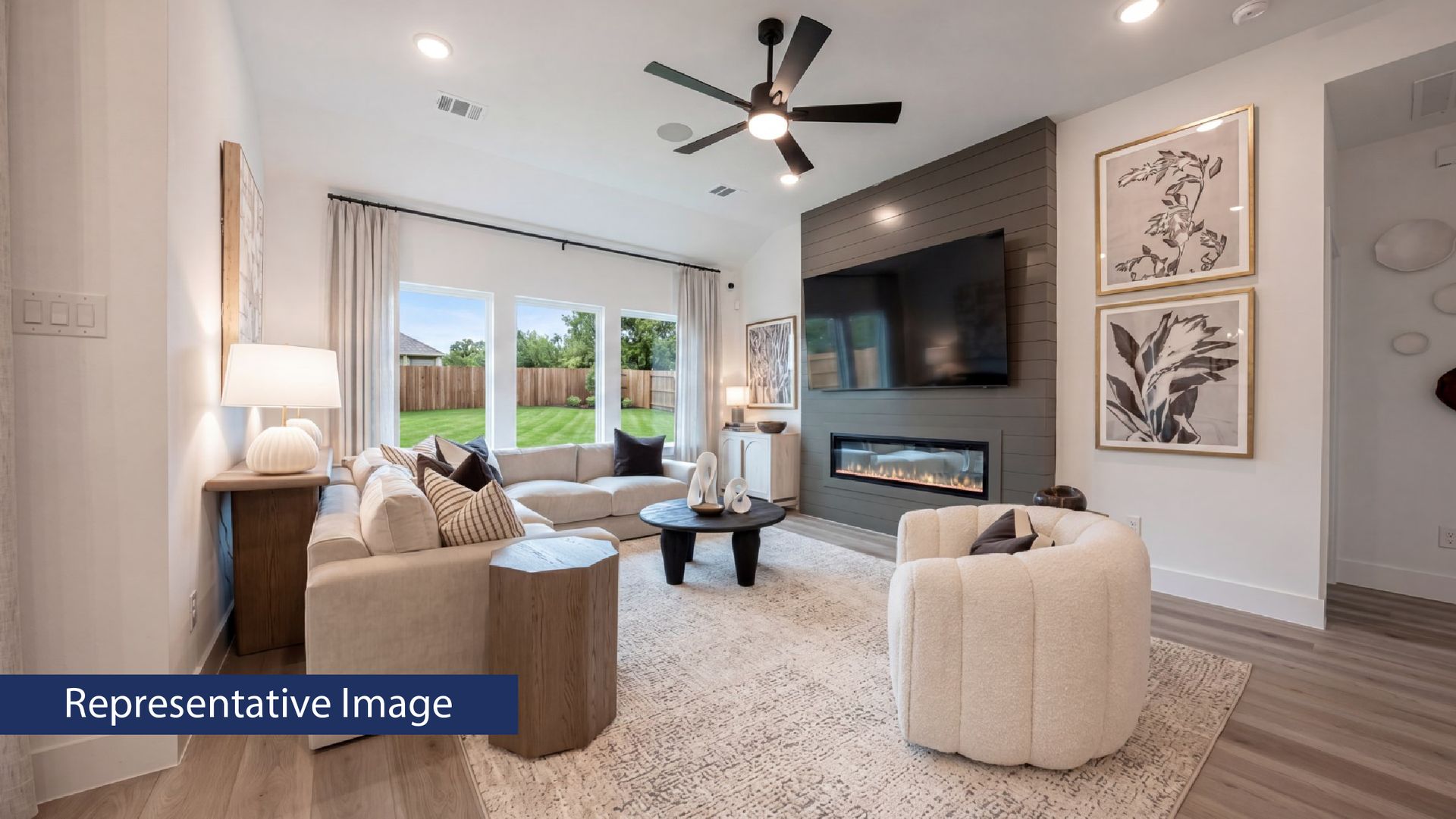 Modern living room with fireplace, large windows, and cozy seating area.