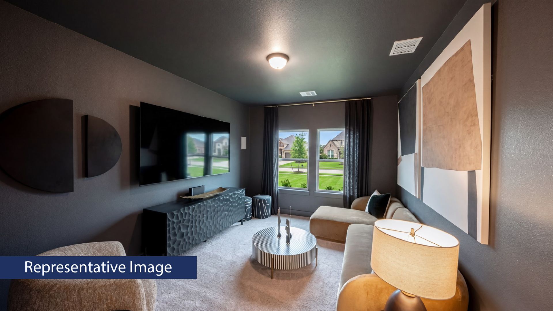 Modern living room with dark walls, large TV, and abstract art.