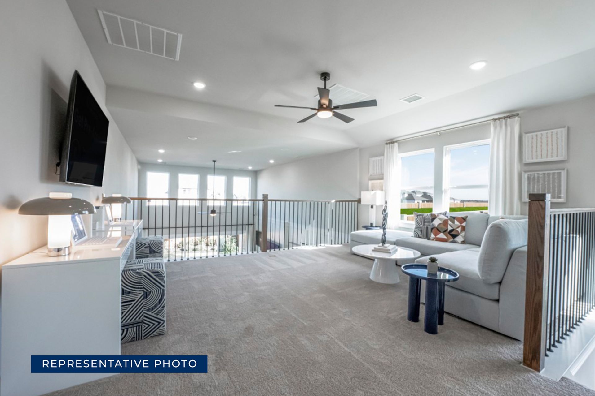 Spacious modern living room with sectional sofa and large windows.