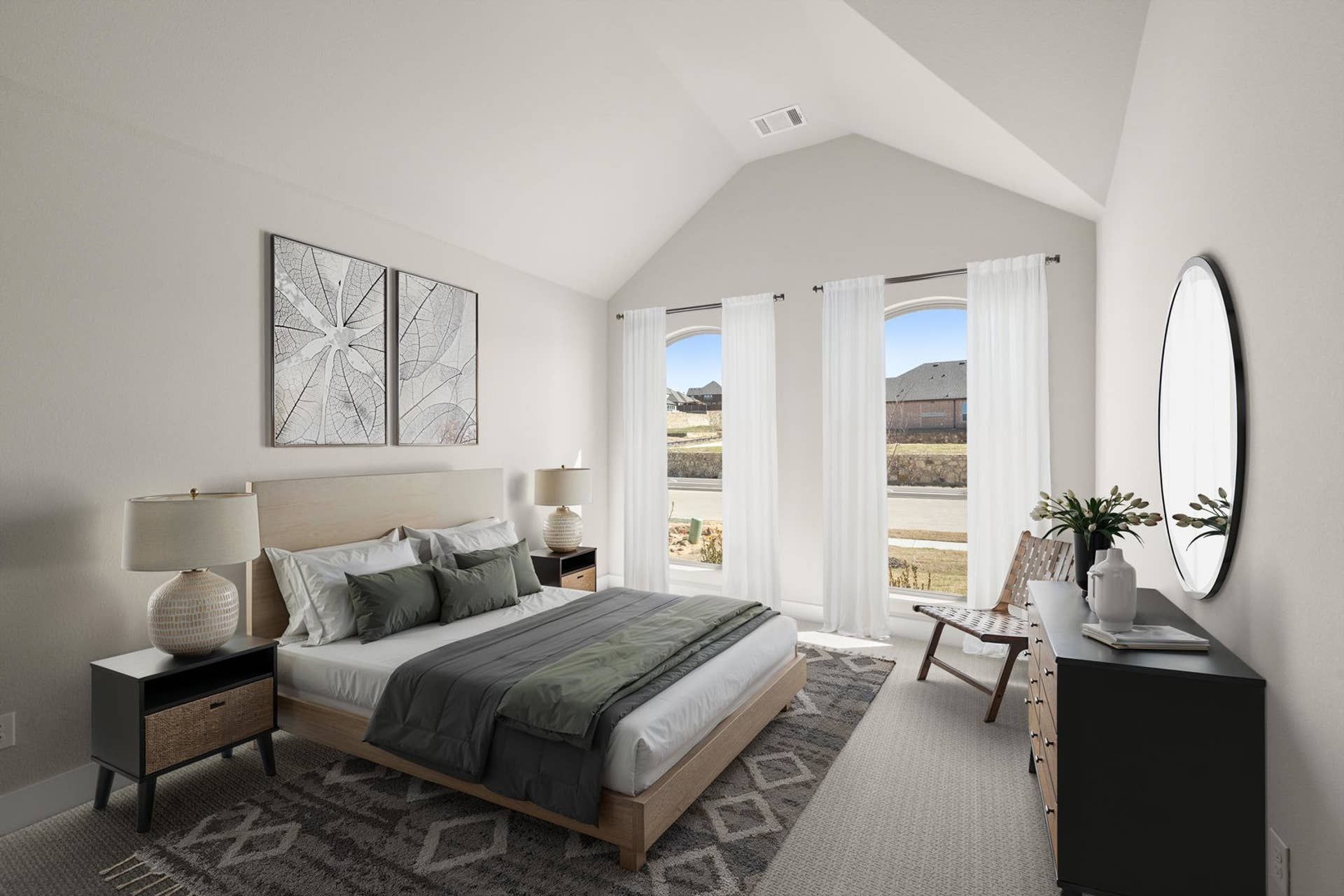 Bright bedroom interior with vaulted ceiling, large windows, and modern decor.