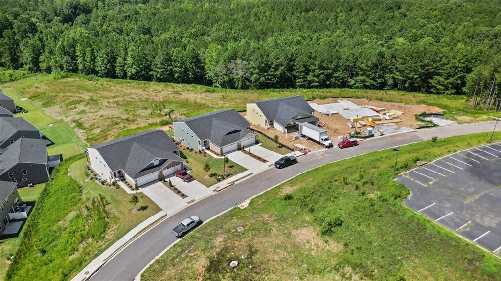 New construction homes with attached garages, concrete driveways, and manicured lawns