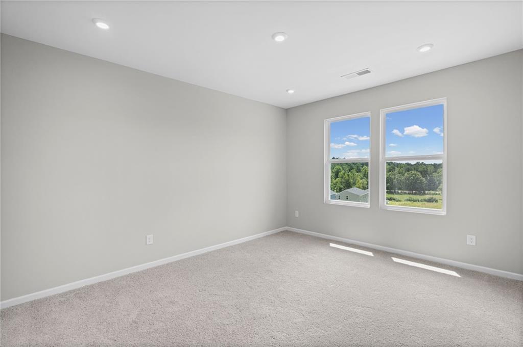 Recessed ceiling lighting illuminates the room