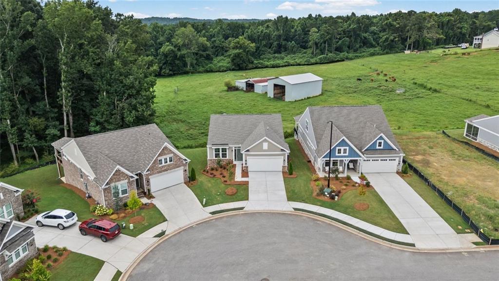 Newly constructed single-family residence featuring a two-car garage and a paved driveway