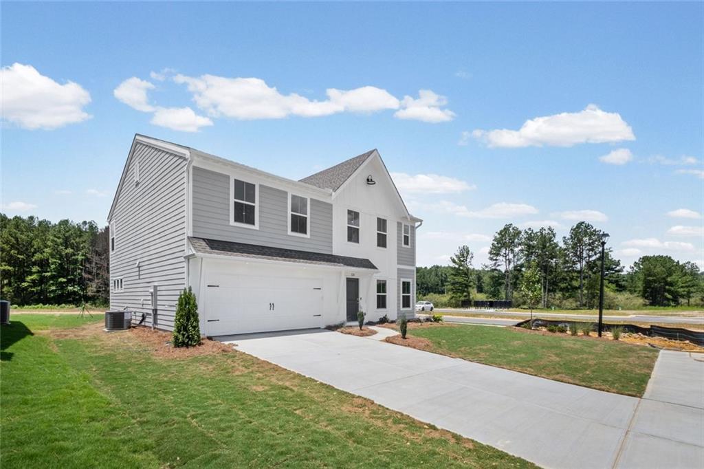 Modern two-story residence featuring light gray siding and white trim