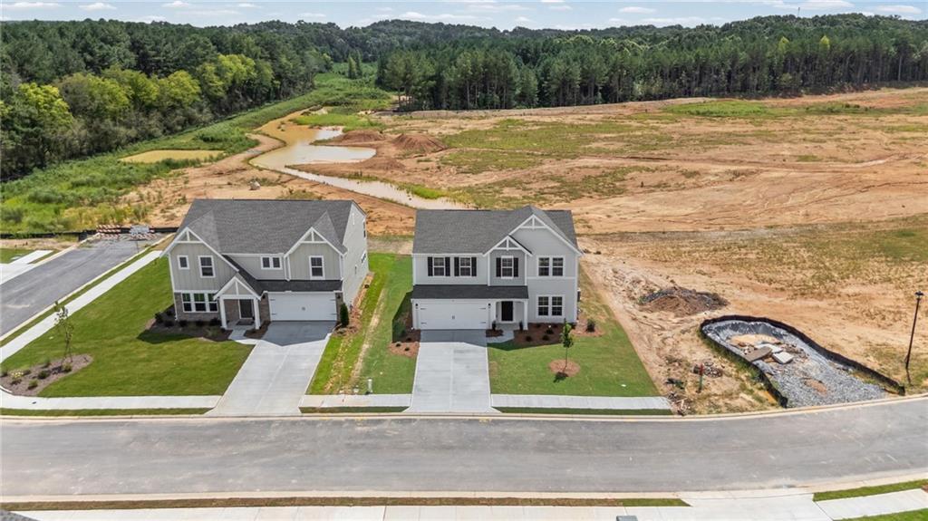 Two-story residences with attached garages, concrete driveways, and manicured lawns