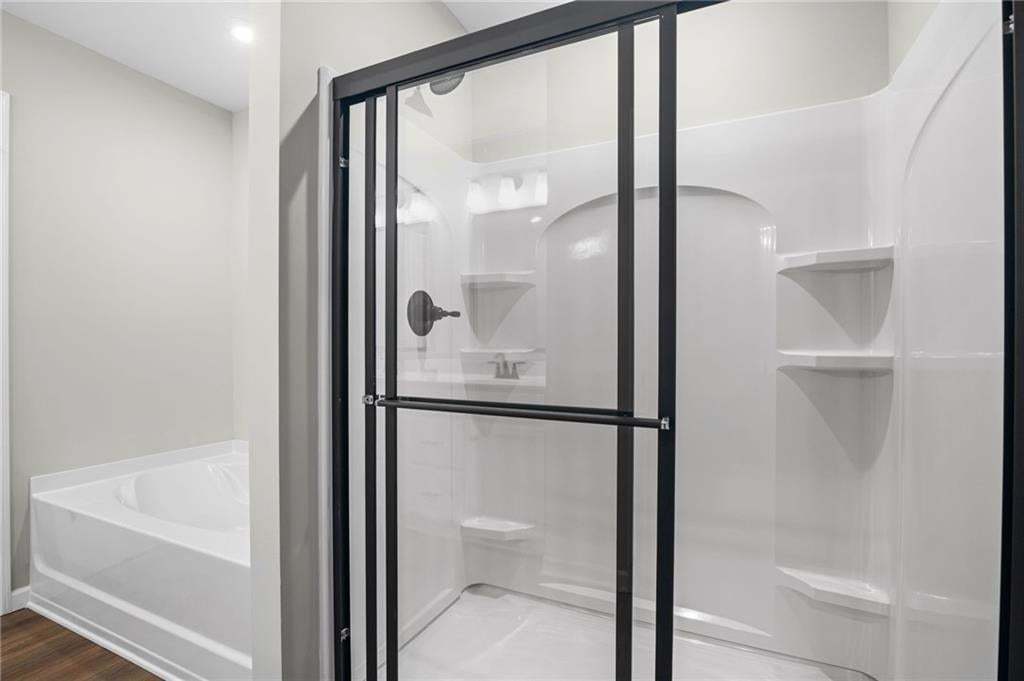 Shower enclosure with clear glass paneling and matte black framing