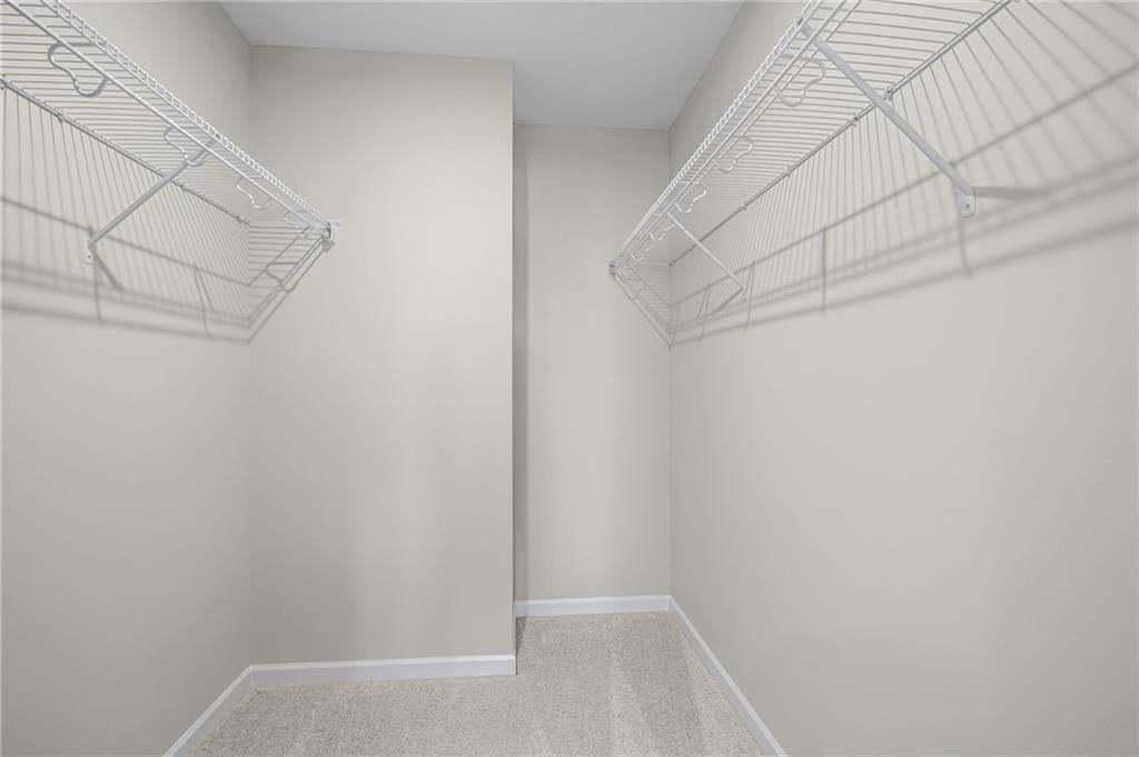 Recessed closet with wire shelving and light-colored carpeting