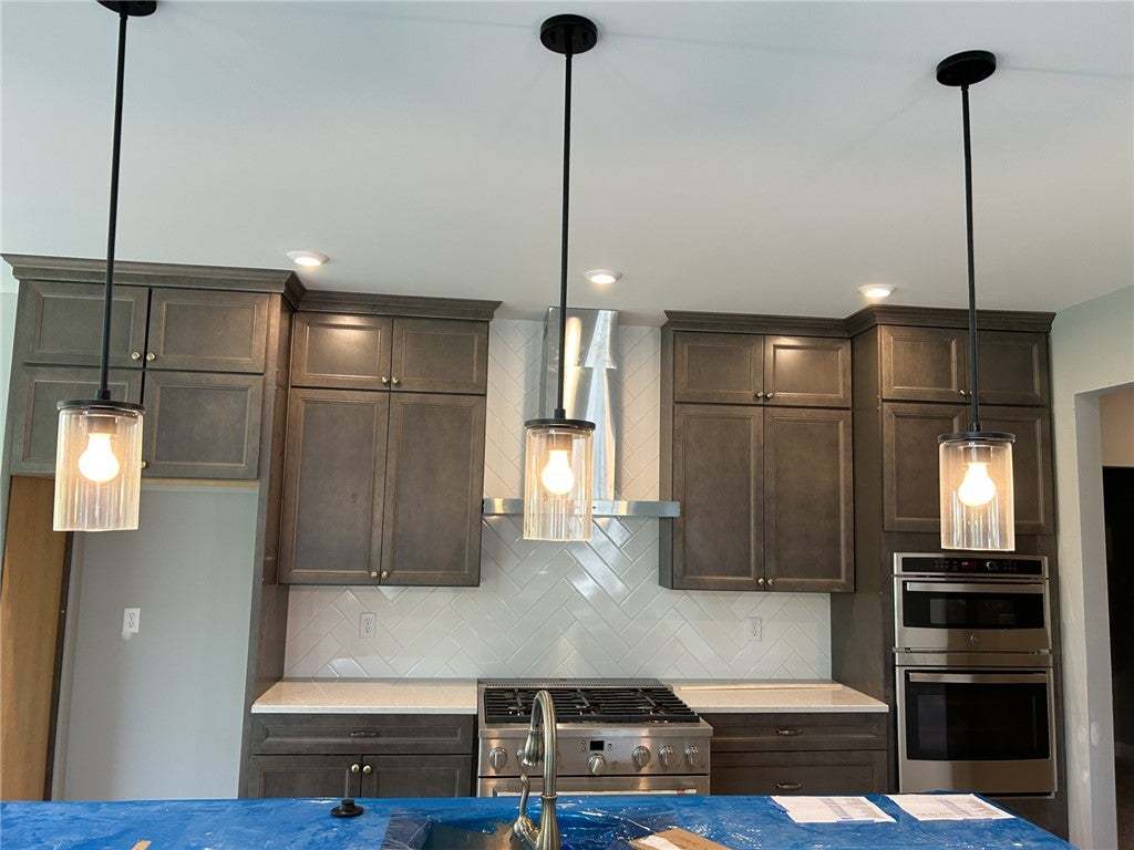 Rich wood cabinetry meets a herringbone tile backs