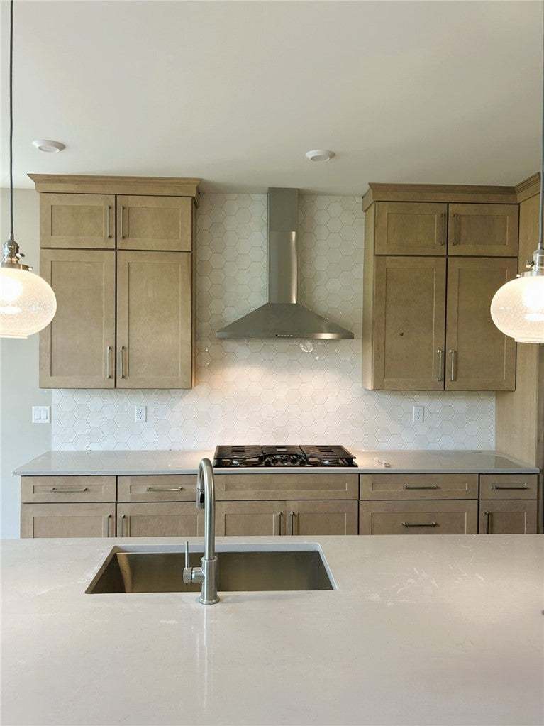 Fine cabinetry and sleek stone countertops define