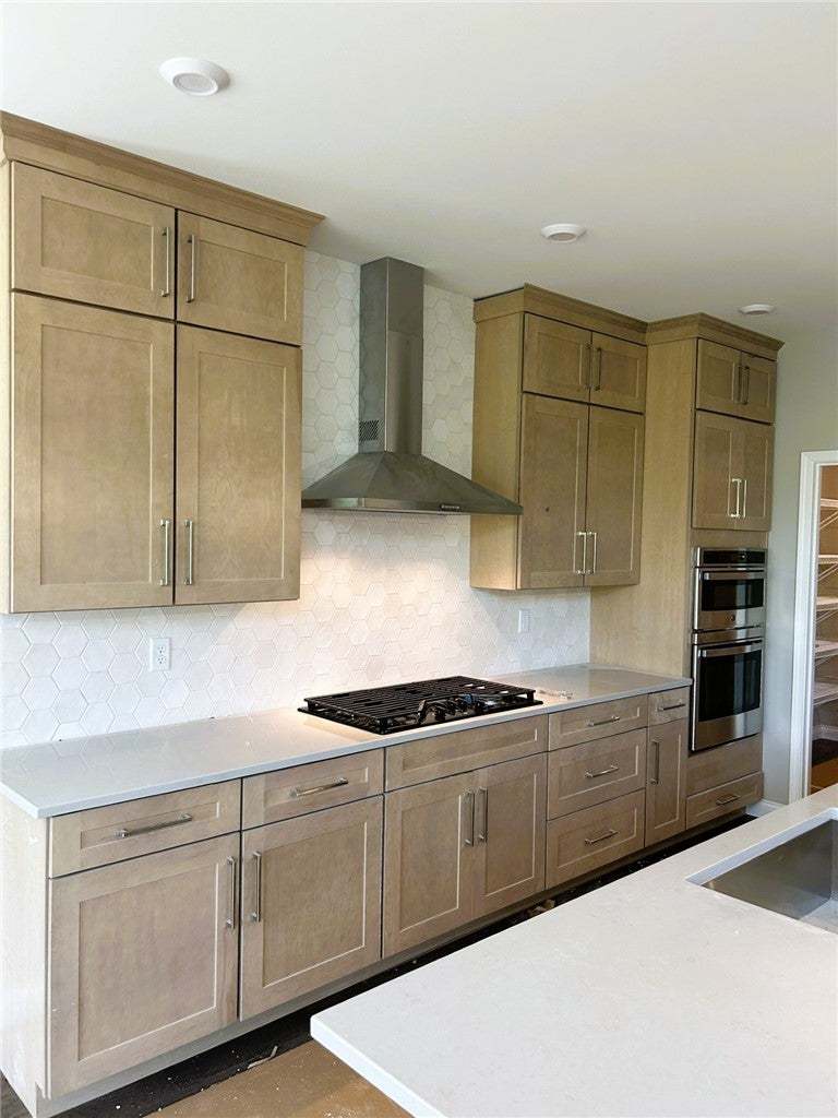 Fine cabinetry and sleek stone countertops define