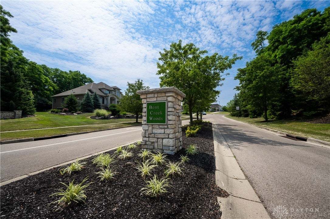 Enter this tree-lined community through a stone mo