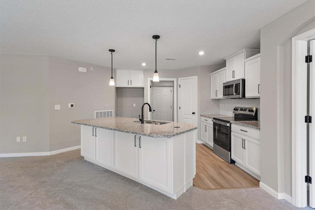 A well-appointed kitchen showcasing a spacious cen