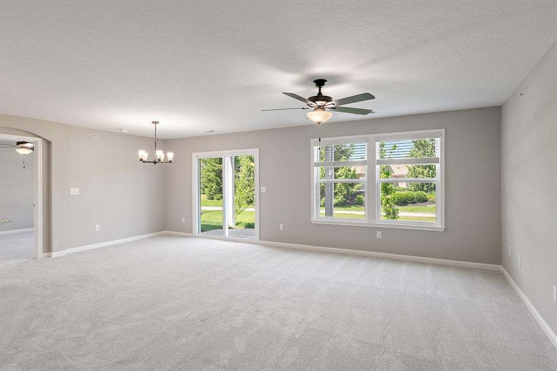 This generous living area boasts plush carpeting a