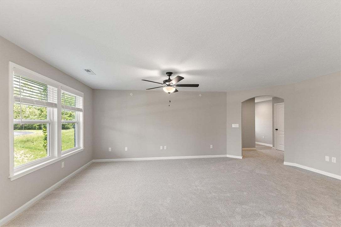 A spacious living area awaits, featuring plush car