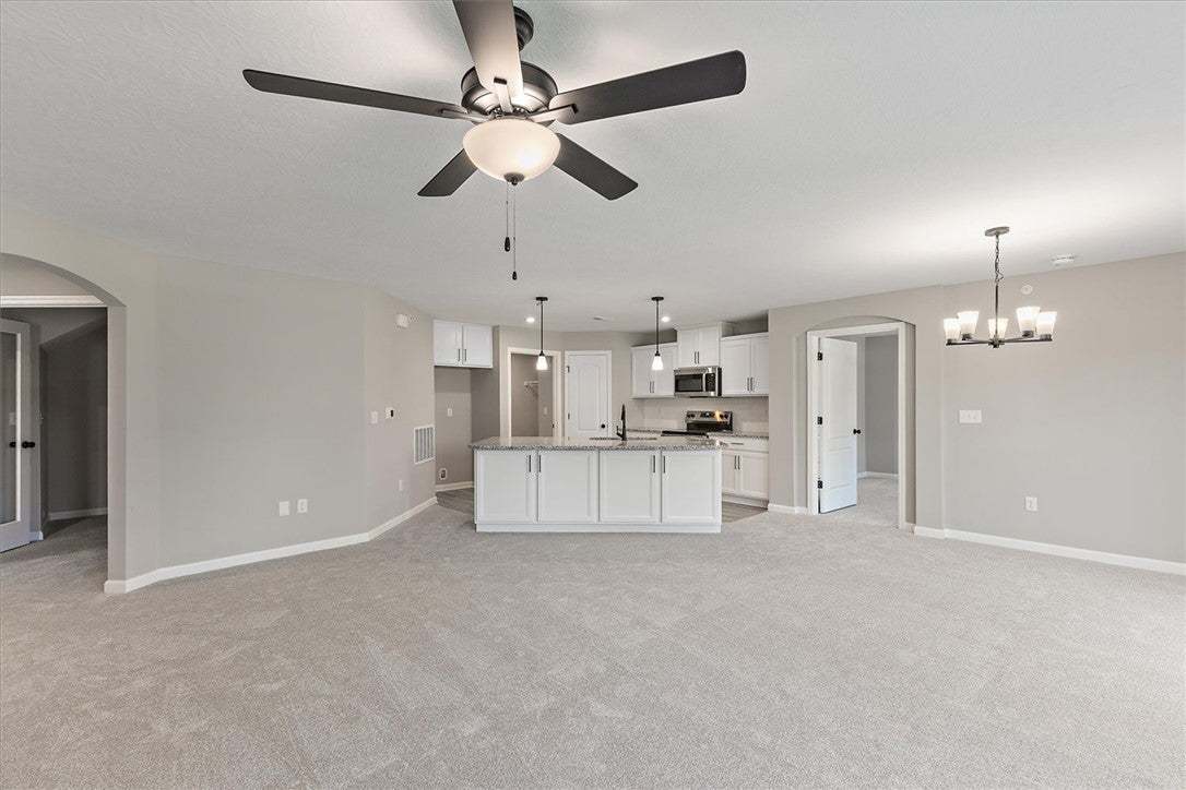 This open concept living area boasts a kitchen isl