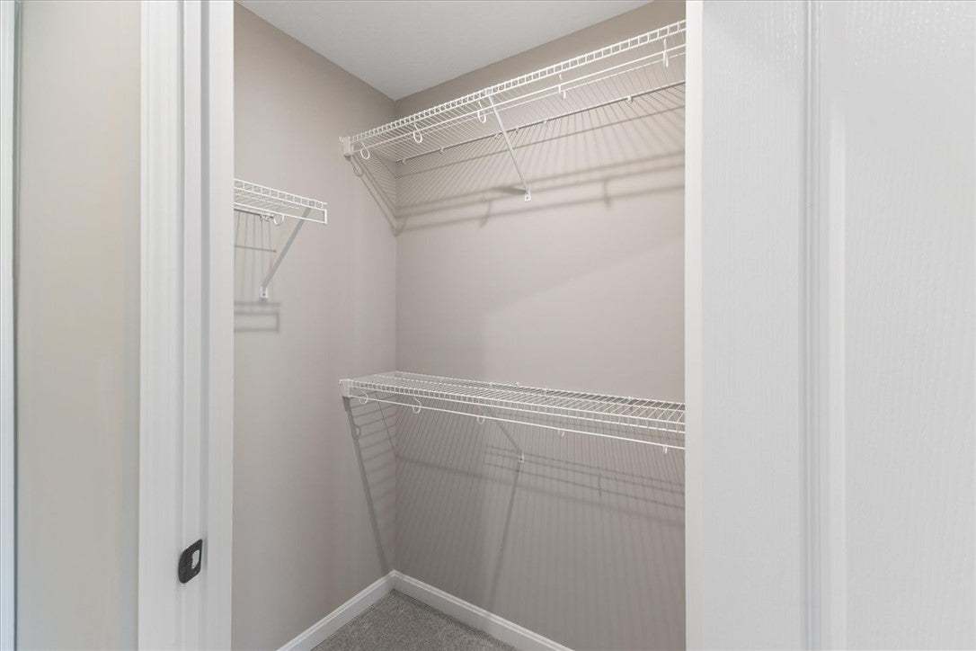 This convenient walk-in closet offers ample wire s