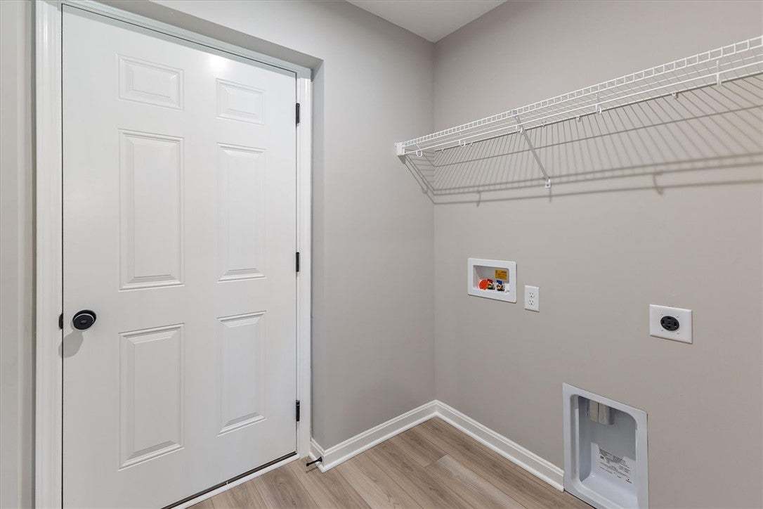 Functional laundry space featuring durable wood fl