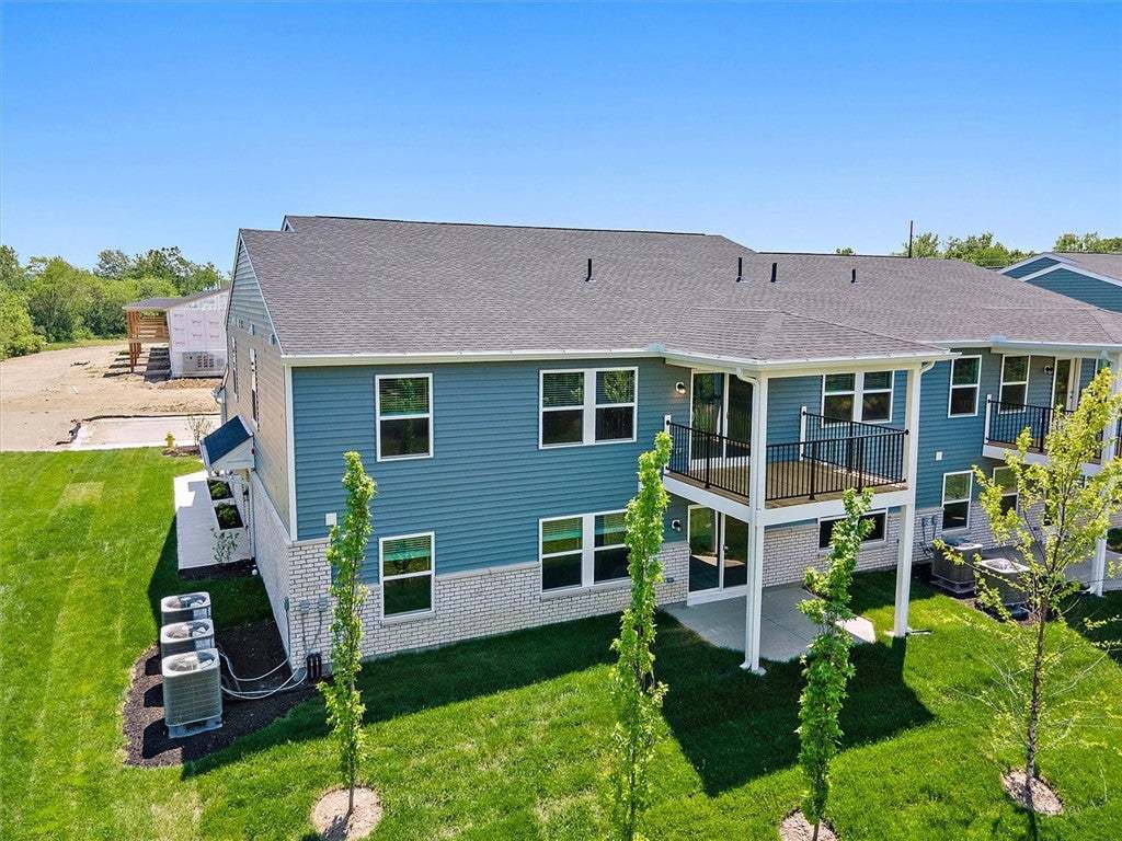 This new construction features modern siding, a de
